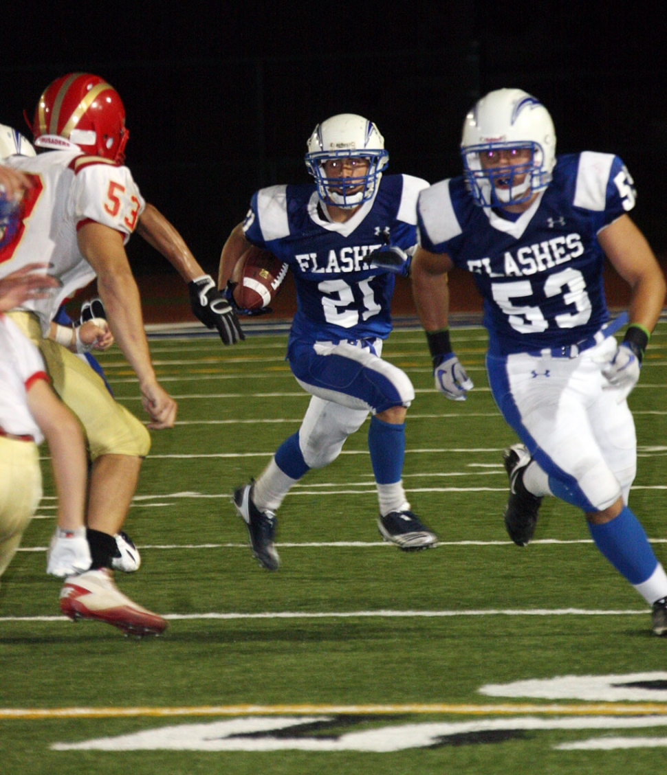 Sammy Orozco #53 blocks for running back Nick Paz #21 against Village Christian.