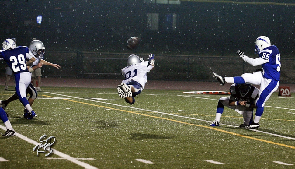 Frazier Mountain’s player dives in the rain to block the punt kicked by Lalo Gomez. Robert Bonilla had two interceptions, one for a touchdown. Joseph De La Mora had 12 tackles and an interception. 