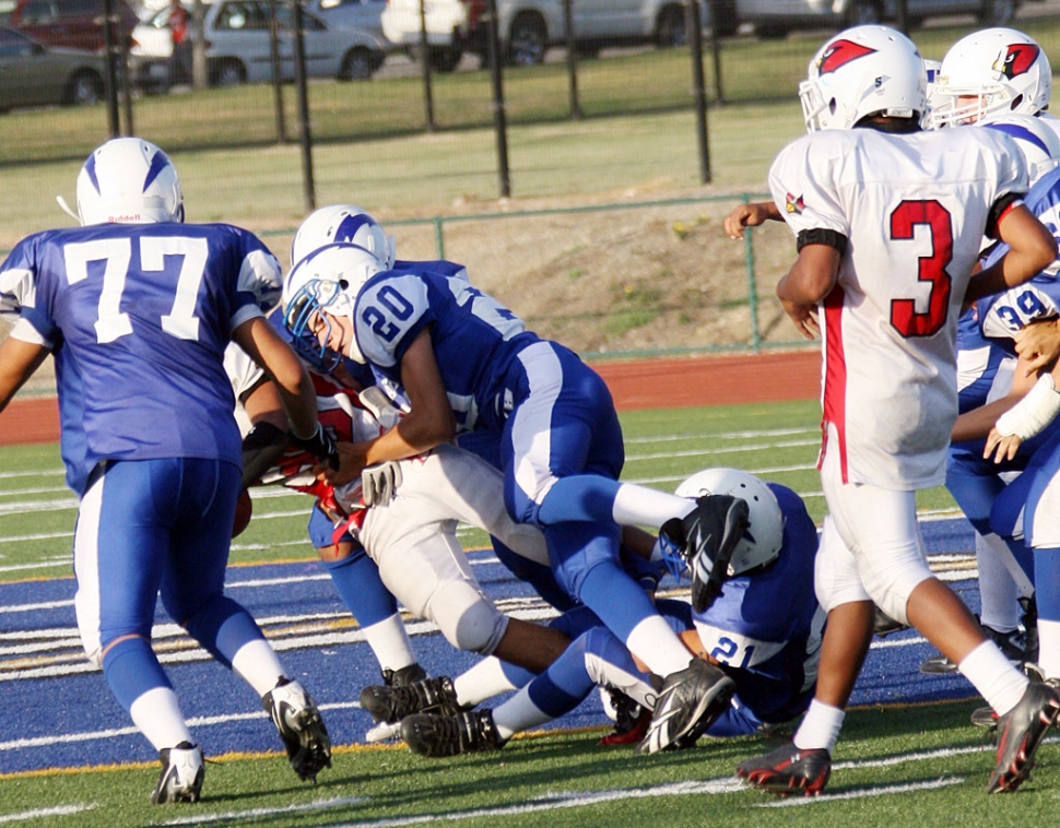 Lalo Gomez #77 and David Cabral #20 do a great job on defense against Bishop Diego. J.V. lost to Bishop 21-24. Touchdowns were scored by Audrey Sanchez, Mario Hernandez and Edwin Batan. Noe Magana scored a two point conversion and Gomez had two P.A.T.