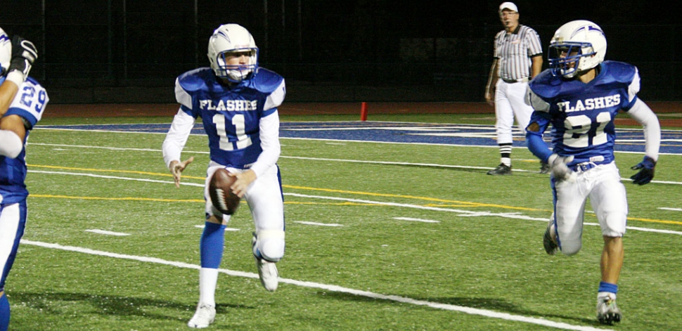 Corey Cole #11 shovels a pass off to Nick Paz during Friday night’s game. Cole rushed for 55 yards and 3 touchdowns and passed for 73 yards. Paz rushed for 94 yards. Zach Golson had a 33 yard interception return, 98 yards rushing and a 12 yard touchdown run.