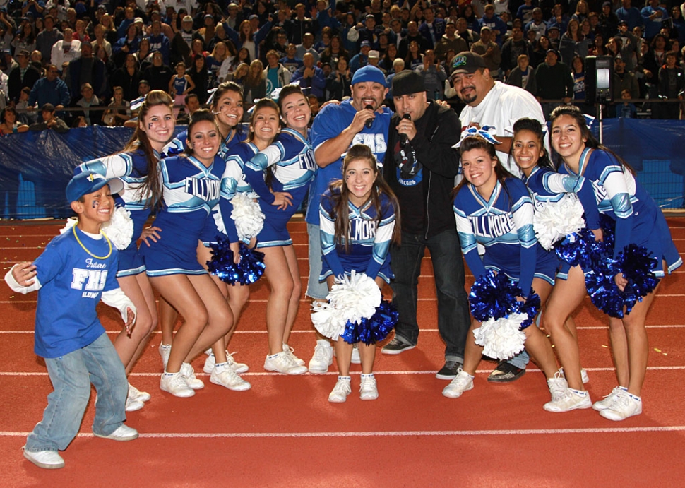 Fillmore High School Cheerleaders are pictured with Rico, Mambo and Chucho from Q104.7. Rico, who is from Fillmore, and Mambo from Santa Paula entertained the crowd during half-time.
