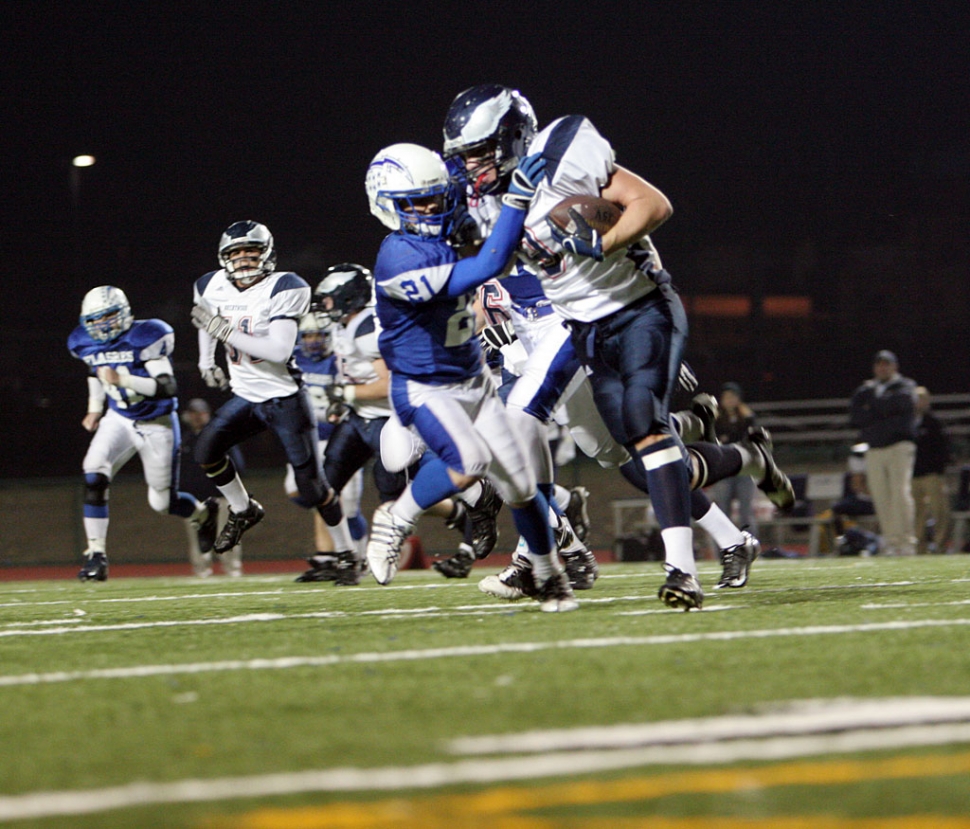 Nick Paz #21 makes a fantastic tackle against Brentwood. Paz has 176 yards rushing contributing to a team total of 412 yards of total offense.