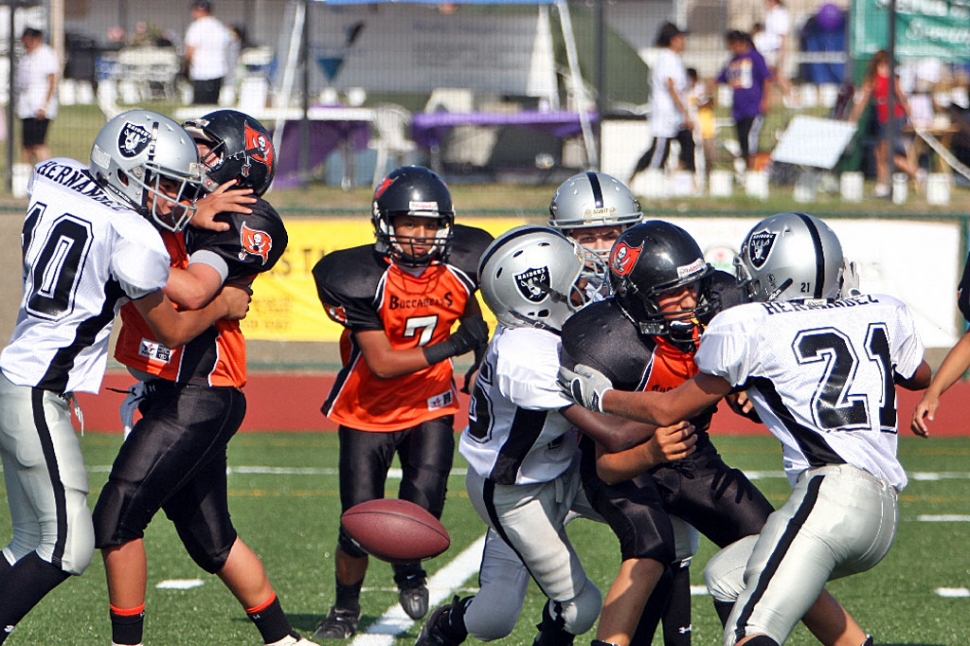 Joe Wilmot stripping the ball away from an Outlaw running back.