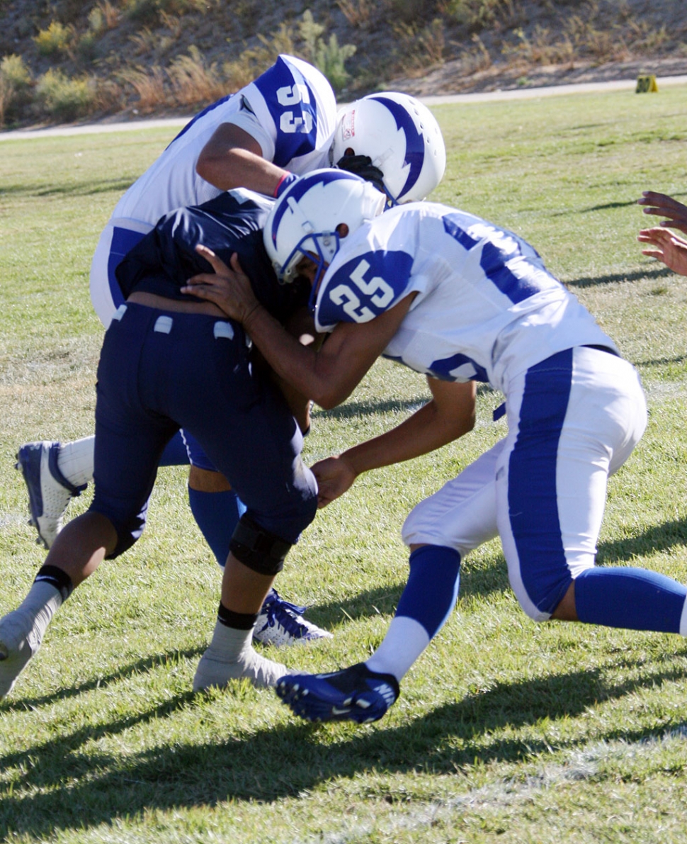 George Orozco #53 and Alex Banales #25 make a great tackle to bring down Frazier Park’s runningback.