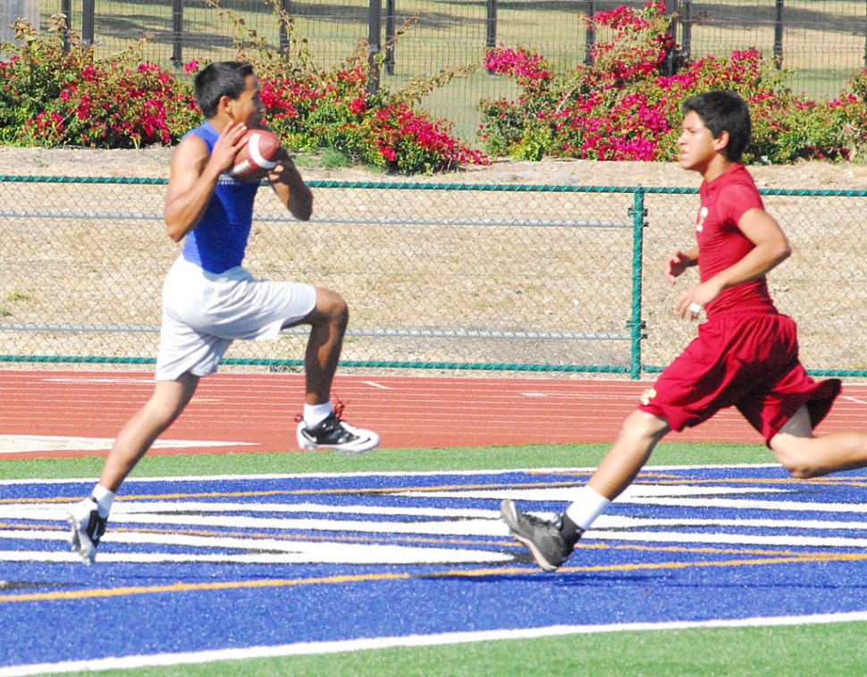 A junior varsity player catches the ball in the end zone.