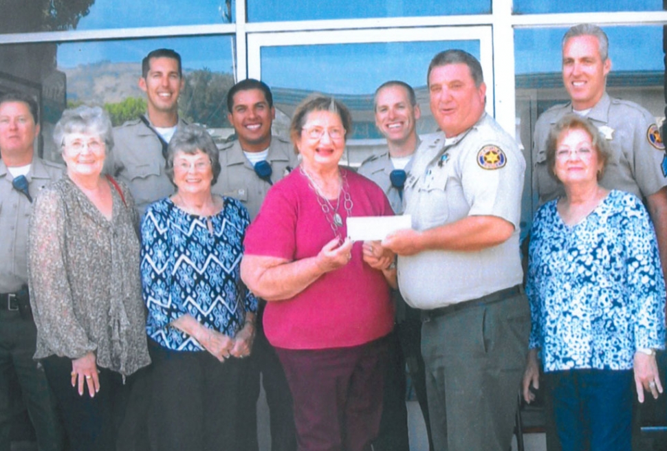 FWSC President Jeanne Klittich presents the check to Police Chief Dave Wareham along with several of our local deputies,  Enjoying the moment are Club members Donna Voelker, Tobey Bowers and Marilyn Griffin.