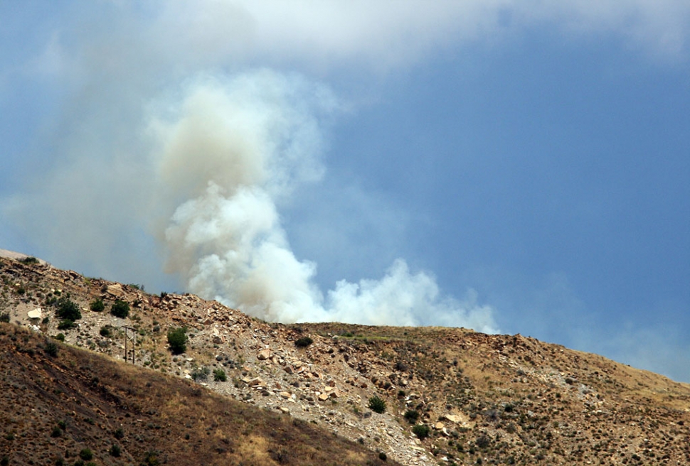 An underground thermal fi re, doused by this helicopter, surfaced again Sunday, June 7, at Squaw Flat, in the Sespe Condor reserve. The approximately 2:00 p.m. fire sent billows of smoke high above Goodenough Road. Ten acres were consumed, burning north-east of the geo-thermal anomaly. No structures were involved in the brush fire. (Photos by Jeff Muth)
