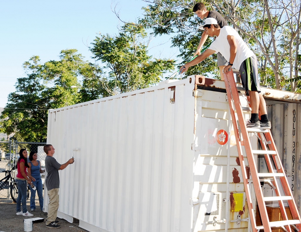 Volunteers paint the Grad Nite Live Storage pod.
