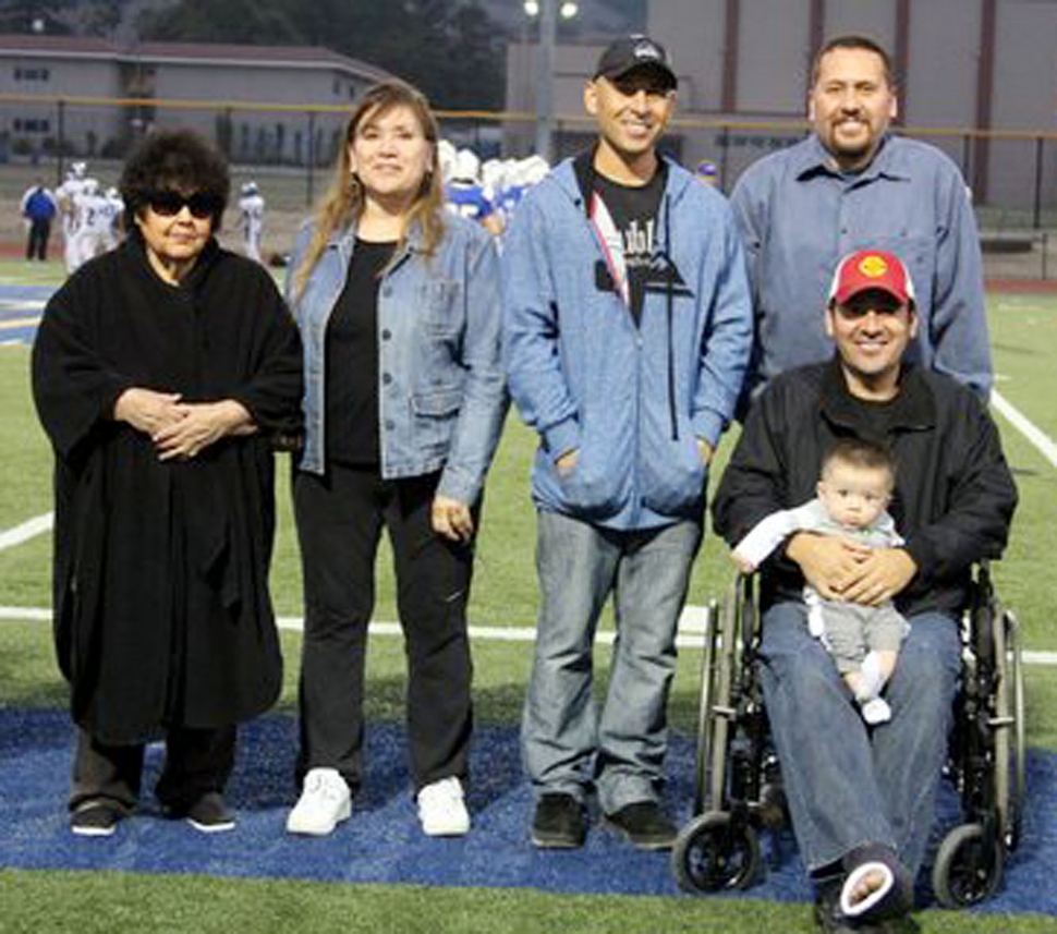 J.V. Cheerleaders escorted a few of the Hall of Fame recipients on the field. Adolf Valquez is wearing his Lettermans Jacket. Right is Jim Reisgo.