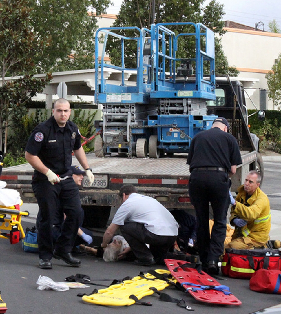 Paramedics treat Helen Shannon 86, after she was struck by a truck moving in reverse.