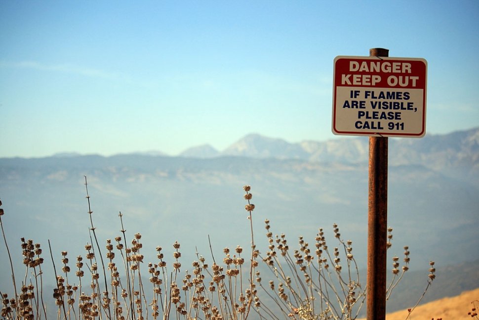 The geological anomaly above Little Sespe Canyon continues to smoke from within the mountain, and the U.S. Geological Survey is stumped. The ground continues to burn, as shown in the photo, scorching the brush.  Authorities speculate that oil or some other hydrocarbon is the cause of the underground blaze. A probe was recently inserted 18-inches into the earth at the hotspot, measuring 940 degrees with a previous reading of 812 degrees.  Smoke can be seen intermittently at the site. A sign has been posted reading “Danger - poison gas may be present - thermal anomaly steam and smoke may be visible - if you see flames call 911 - Keep Out.” Authorities poured a 500 barrel Baker Tank of water on the site but geologists warned that the saturation may result in a landslide, according to a source. Fire Department spokesman Ron Oatman commented that they don’t think it is any type of volcanic activity, but want to rule it out. Bottom line, if you are hiking near the area and see smoke, don’t panic; if you see flames, call the fire department. (All Photos by Jeff Muth)