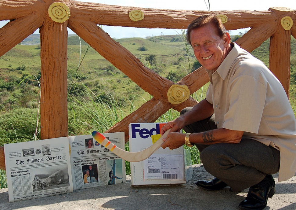 John King (screen names Centurion and Oceans11) in the Philippines with 2 recent editions of The Fillmore Gazette and a hand made boomerang from Fillmore's previous mayor and current City Council Member Steve Conaway.
