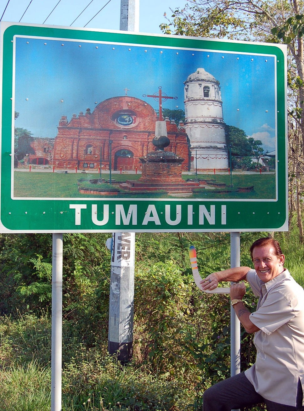 Photo of John next to the Tumauini road sign.
