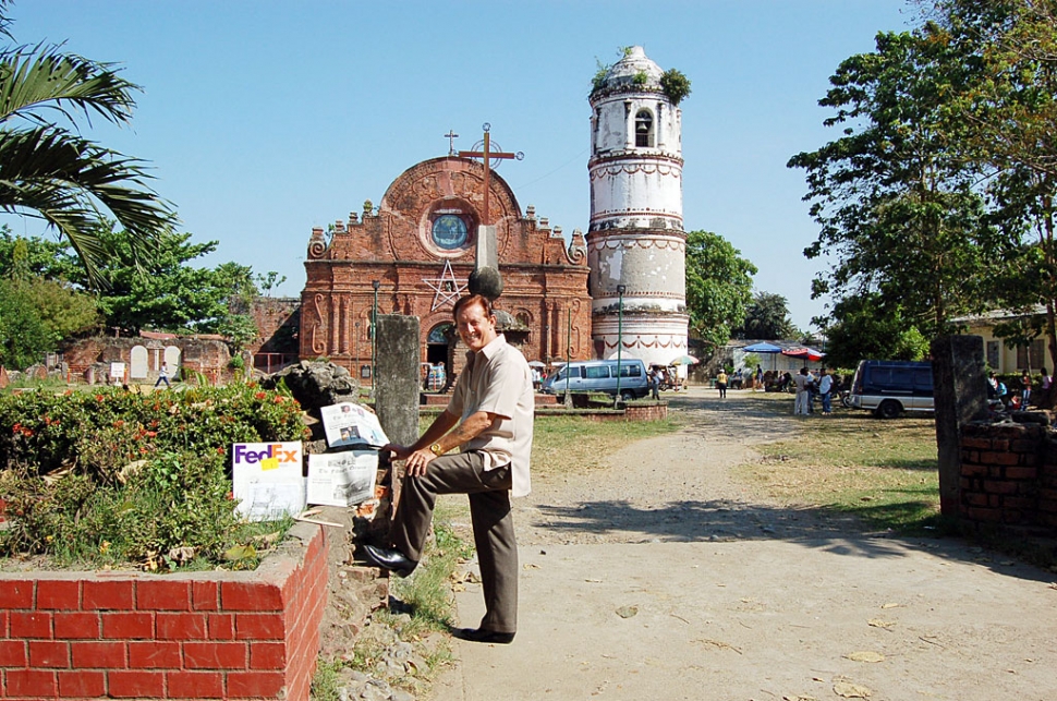 Photo of John in front of the St. Mathias Church shown in the road sign. The church was built in the 1780s by the Dominicans.