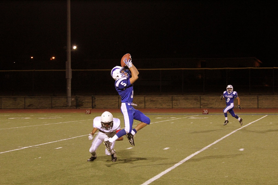 J.V. #5 Jose Perez catches a pass from #7 Hector Sanches for a first down