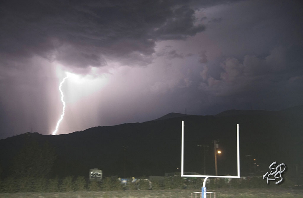 A bolt of lightning struck the Sespe Mountains this past Friday evening, delaying the football game by 30 minutes. [Photo by KSSP Photographic Studio]