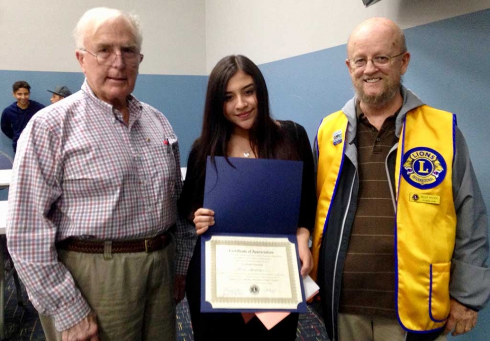 Lions Club members Bill Dewey and Brian Wilson with Lions contest winner Alina Herrera.