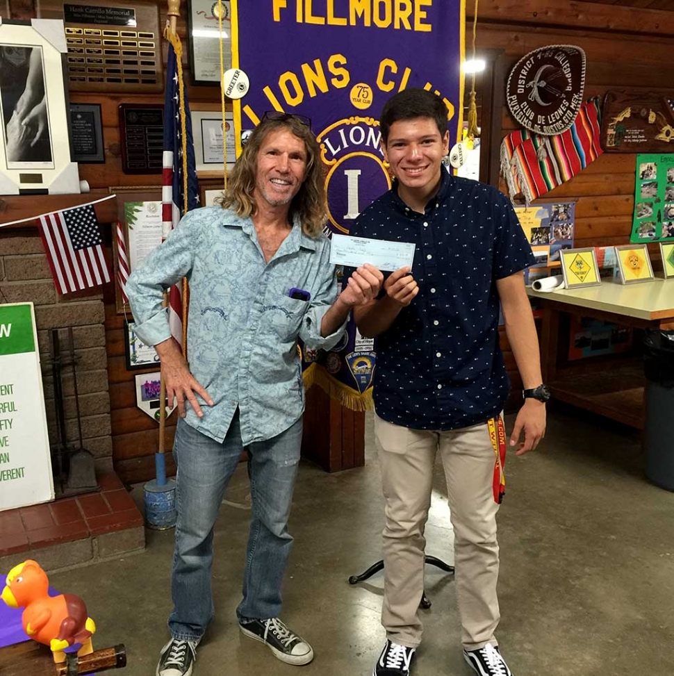 Fillmore Lion Paul Benavidez (left) presents a check for $500 to Leo Club Vice President Jaime Malagon, a senior at Fillmore High School. The Fillmore Lions Club sponsored the new club for young people, which was chartered in 2014. The Lions Club donates money each year to support the Leos. Lions clubs sponsor approximately 5,800 Leo clubs in 140 countries. While helping others in their community, Leos develop leadership skills and experience teamwork in action.