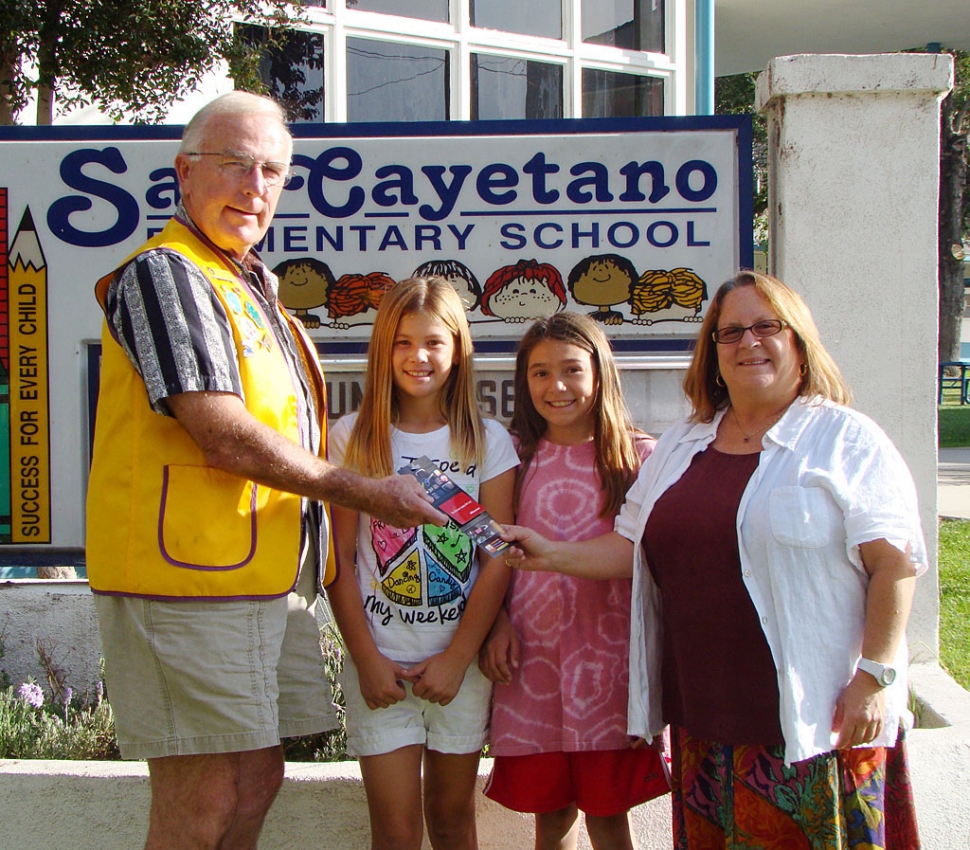 Bill Dewey of the Fillmore Lions is shown presenting a gift card for $500 to Office Depot to San Cayetano Principal Jan Marholin. The Fillmore Lions gave each elementary principal a gift card. San Cayetano will use their gift card for much needed copy paper. Each week students change the school marquee and shown in the picture are Bill’s granddaughter, Victoria Pace and student Tori Villegas. Go Eagles!
