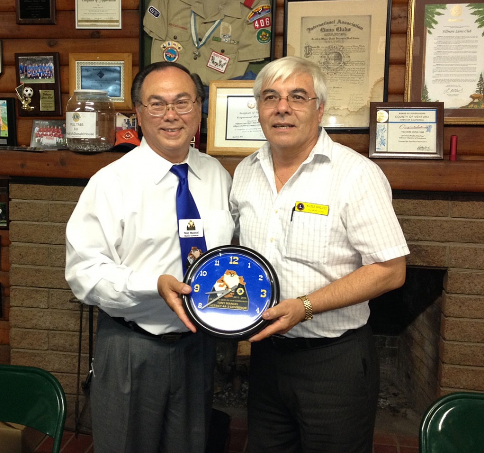 Lion’s Club District 4-A3 District Governor Tony Manuel of Santa Maria made his annual visit to the Fillmore Lion’s Club on Monday, October 1.  After his inspirational remarks to the club gathering, Fillmore Lion’s President Walter presented Manuel with a special clock on behalf of the club.  The clock features Manuel’s insignia for this year, including a Tasmanian Devil.  There were members of other area clubs also on hand for the dinner and presentation by Manuel.  As Manuel said in a recent District Newsletter, My theme this year is, “We are the Gems of our Community” and by working together we will shine and sparkle and stand out from the other organizations, so we will be better recognized and appreciated in our communities.