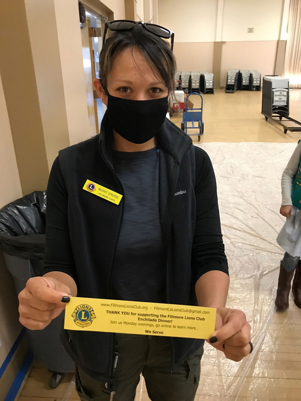 Lion Club member Brandy Lengning holding up a thank you slip.
