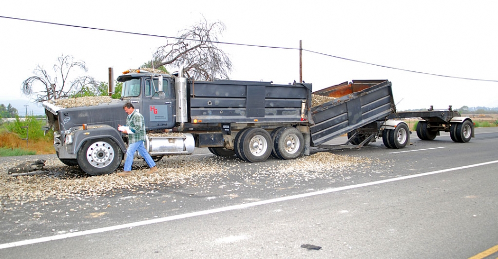 One fully-loaded gravel truck failed to stop for another truck making a right turn on E Street.
