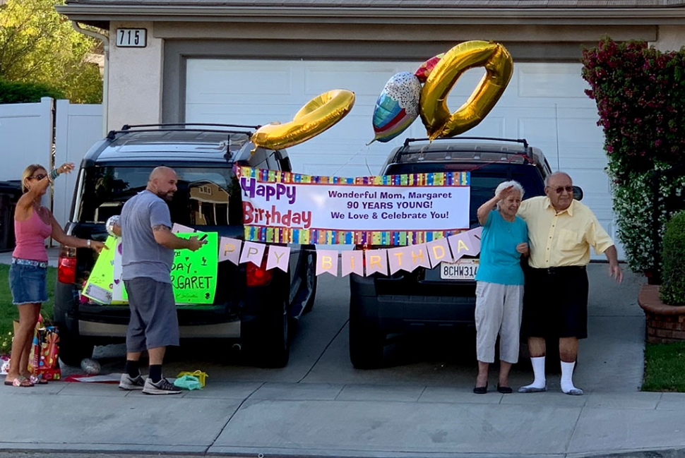 A drive-by birthday parade helped Margaret Torres celebrate her 90th birthday on Tuesday, May 5th. Honking cars covered in birthday banners and balloons drove by her home for a half hour, bringing her flowers, gifts, and love. Margaret has been bringing tasty happiness to Fillmore for 40 years with her popular restaurant “Margaret’s Cocina”. She is pictured with her husband Rudy waving to her many friends. Happy Birthday, Margaret!