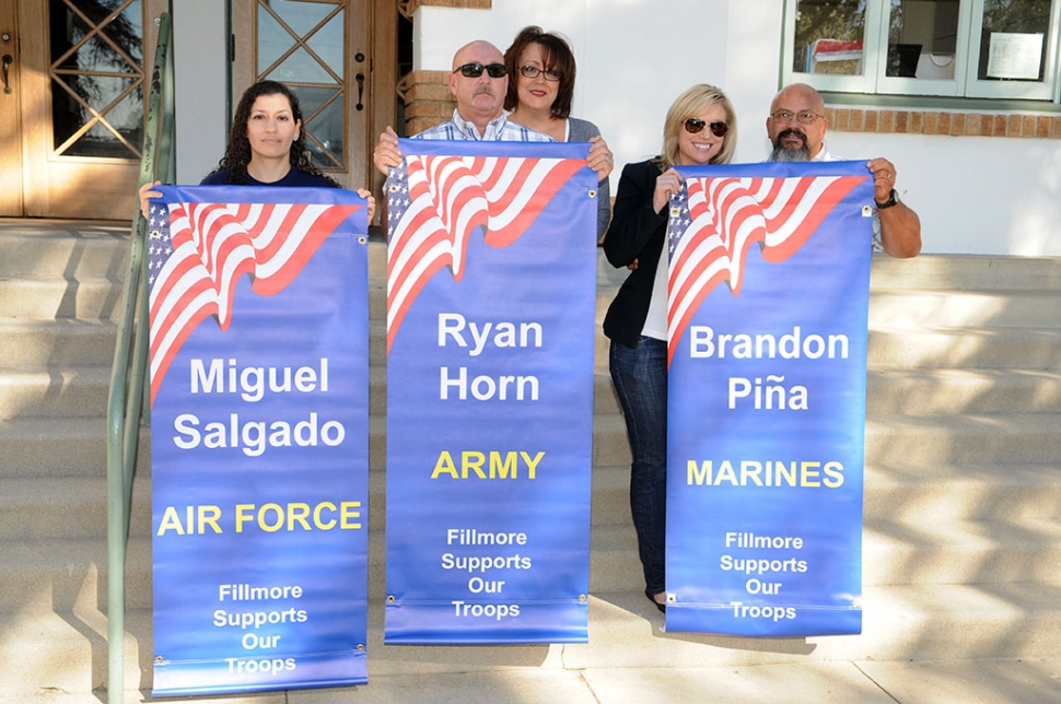 Families of Miguel Salgado (Air Force), Ryan Horn (Army) and Brandon Pina (Marines) display the new banners for service personel from Fillmore. The banners were presented on Wednesday, February 4, 2015.