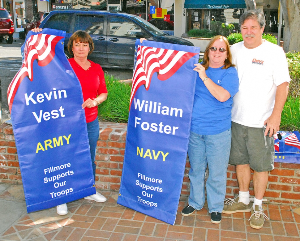 Proud military parents of Kevin Vest and William Foster are pictured on March 8th holding some of the banners hung on Central Avenue, honoring military service personnel.