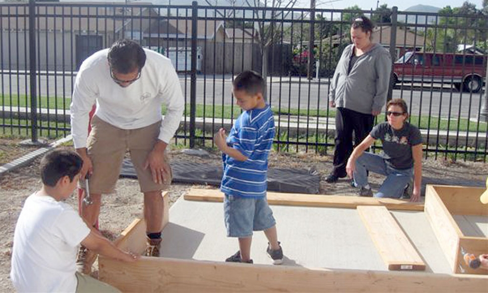 Getting Ready for Spring, Mountain Vista Elementary School planned a garden workday. Staff and Parents volunteered their time on two Saturdays to assemble planter boxes and fill them with soil.  getting them ready for classrooms to begin planting. Pictured are Darren and Joey Zepeda helping Mr. Castro level a planter box as Mrs. Castro and Marie  Molina look on.