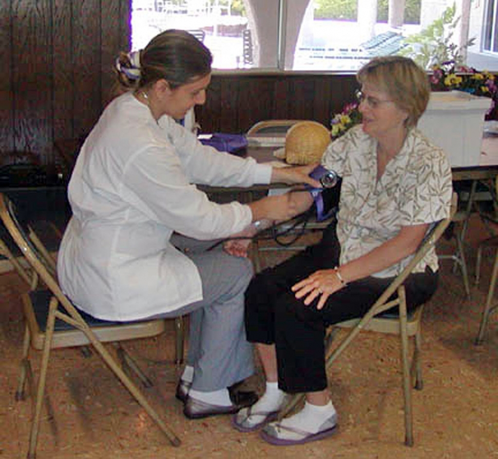 Also show is her assistant taking an El Dorado resident’s blood-pressure.