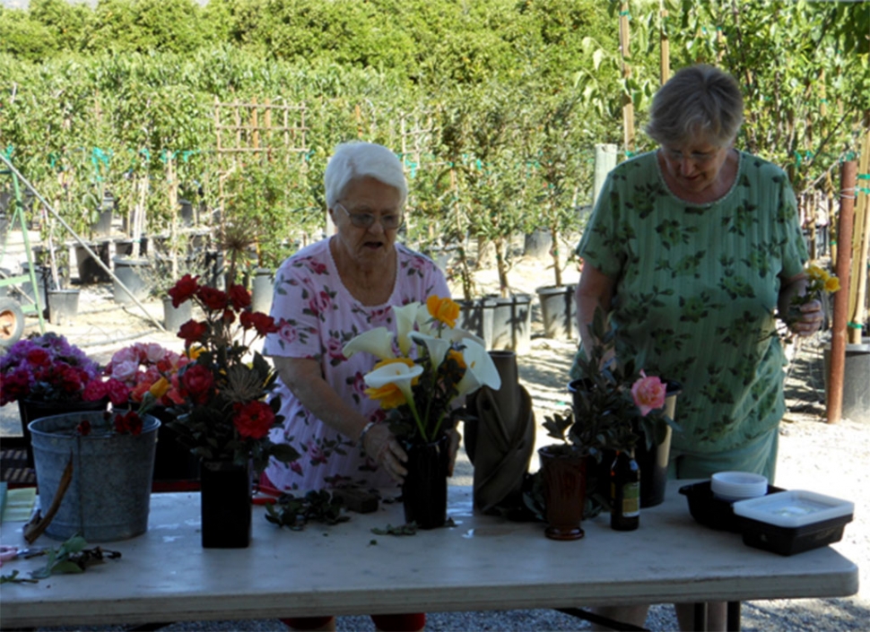 (left) Barbara Schneider and Susan Diller with their demonstration bouquets and arrangements.