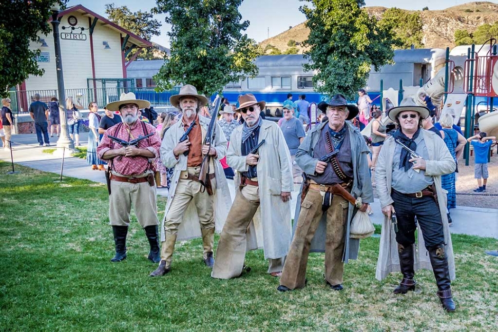 Photo of the Week: "Frontier Gun Fighters ride into Piru" by Bob Crum. Photo data: ISO 400, 16-300mm lens @18mm, f/10 @1/100 seconds.