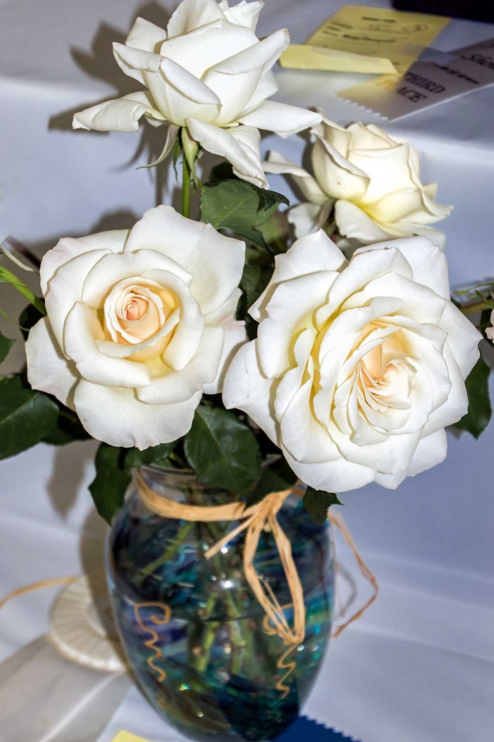 Photo of the Week by Bob Crum. Beautiful white roses displayed at the Fillmore Flower Show. Photo data: ISO 400, 48mm on 16-300mm lens, f/5.0, 1/250 sec.