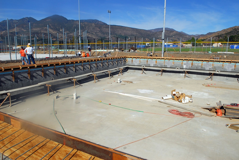 Above, the pool has received its blue tile strip and is prepared for its final plaster coat.