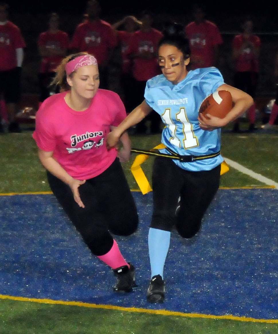 Junior Candice Stines gets ready to pull Leslie Hernandez’s flags during the Powder Puff game. Seniors won 12-6.