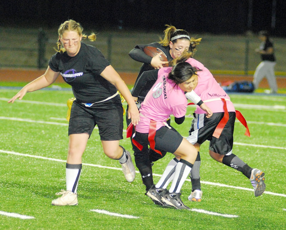 Senior Brenda Magana (pink) and teammate stop Junior Kellsie McLain from running the ball. Also pictured Jessica Givans.