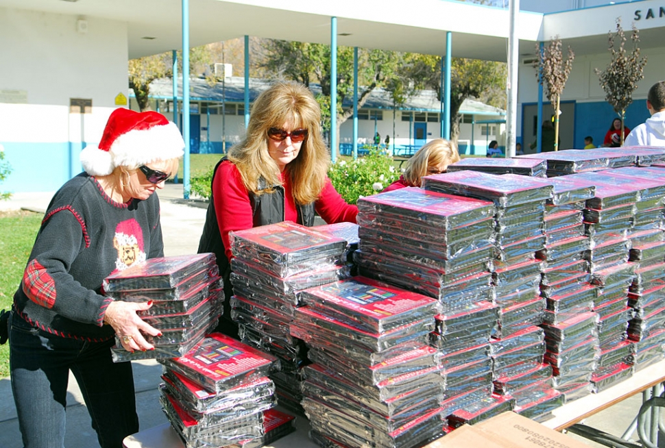 Lynda Miller, right, founder of the Support for the Kids Foundation, readies just some of the many gifts distributed to students at San Cayetano and Piru Elementary through the foundation.