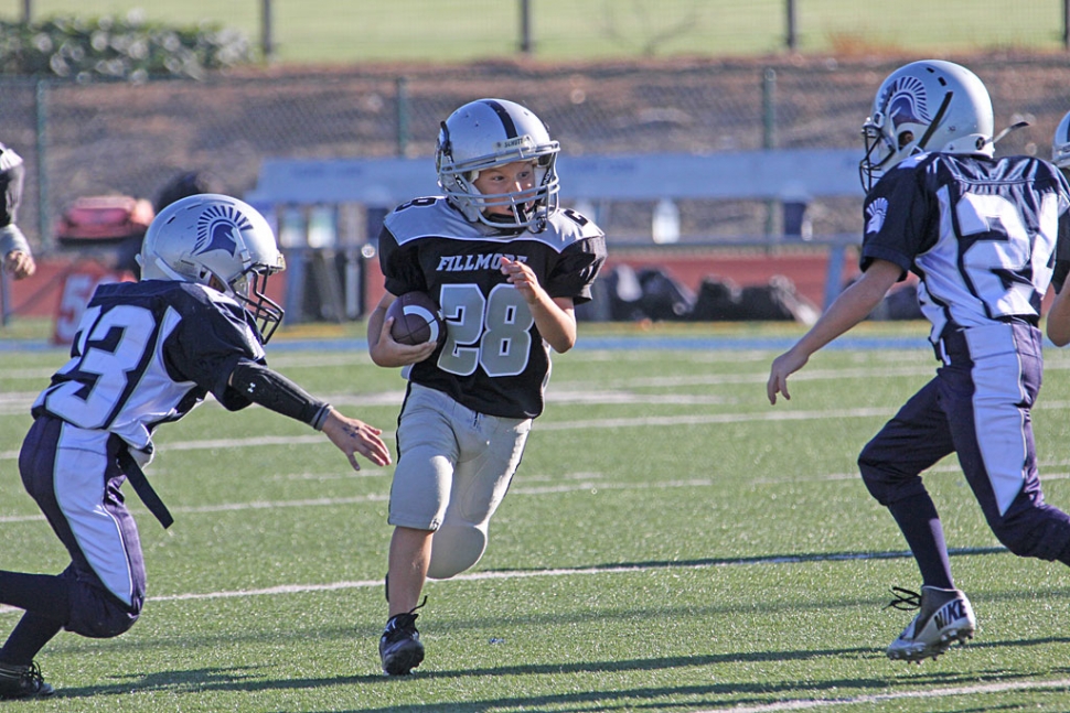 Last Saturday the Fillmore Raiders played Moorpark. #28 from the Fillmore Raiders Mighty Mite team tries to avoid the tackle. Raiders Photo’s courtesy of Crystal Gurrola.