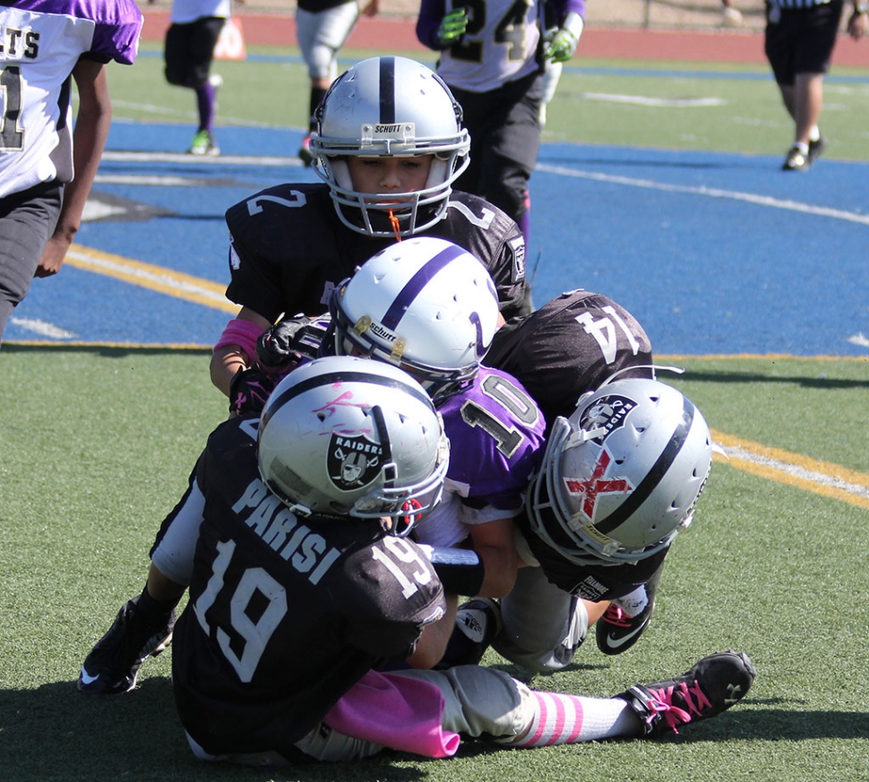 Raiders #19, #14, #2 make a group tackle