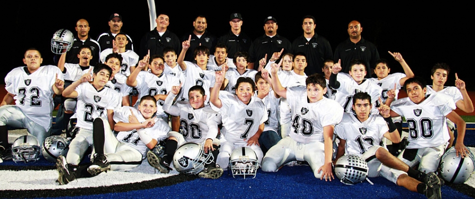 Congratulations to Fillmore’s J-2’s Raiders football team. The Raiders beat Santa Paula last Saturday 30-14 for the Conference Champs Title. They hold a record of 8-0. They will continue in playoffs this Saturday against Westlake with a home game at 4:00 pm. Pictured above are the J-2 Raiders football players: Vincent Vargas, Ramiro Garcia, Aaron Cronin, Ryan Riberdy, Bakari Cook, Tyler Esquivel, Torey Negrete, Alex Tovar, Adam Jimenez, Deangelo Castro, Brendan Aguilar, Sonny Vigil, Ivan Hurtado, Eddie Cardenas, Michael Castro, Val Pillado, Johnny Chaveste, Steven Chaveste, Sammy Holladay, Nathan Martinez, Ernie Rangel, Joe Gonzalez, and Omar Valdivia. Coaches: Timmy Pillado, David Esquivel, Joseph Aguilar, Vince Vigil, Ram Medina, Cameron
Bennett, Matt Chaveste, Val Pillado, and Larry Tovar Jr. (Photo by Harold Cronin)