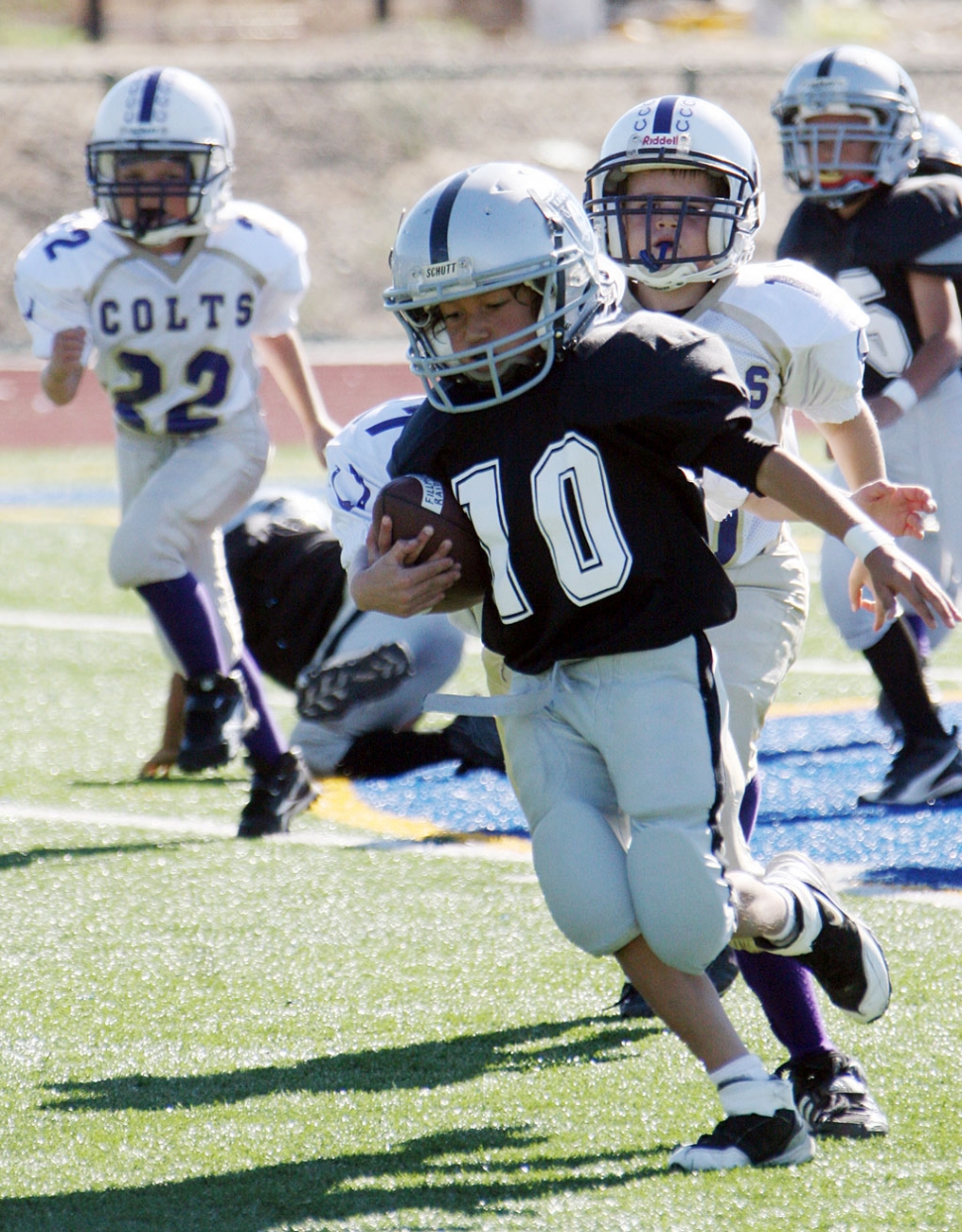#10 of the Raiders Mighty Might’s runs the ball, last Saturday against the Crown Vally Colts. Raiders won 46-20.
