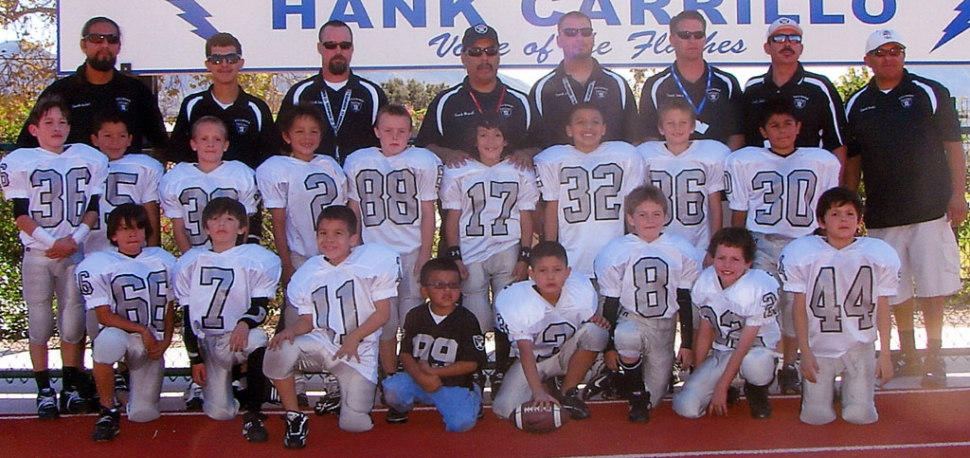 2010 Mighty-Mite Silver: Pictured above: Head Coach: Miguel Lagunas; Assistant Coaches: Hugo Virto, Louie Rodriguez, Hector Sierra, JT Wyand, Eric Crawford, Rudy Alcantar, James Reiman, Kevin “Chalupa” Brock and Alfred Jimenez. Players: #2 Joseph Sierra, #3 Justin McElroy, #7 Anthony Campos, #8 Ty Wyand, #11 Jimmy Carlos, #15 Eduardo Jimenez, #17 Joshuah Lagunas, #22 Ryan Gonzalez, #30 Nicholas Jimenez, #32 Hugo Virto, #33 Reese Satterfield, #35 Gavin Gunter, #36 Christian Alcantar, #44 Dylan Sierra, #66 Michael Rodriguez, #86 Connor Reiman, #88 Dylan Crawford. Team Mascot: #99 Nico Virto. Mighty-Mite Silver Cheer: (not pictured) Coaches: Rebecca Ibarra, Bandi Hill, Gabi Sandoval; Cheerleaders: Olivia Lagunas, Angelina Delgadillo, Hennassy Marquez, Makenna Ozuna, Desiree Almazan, Siobhan Sandoval, Arissa Ramos, Alena Castaneda, Angelina Mynatt, Madyson Bishop and Linique Aguilera. The Fillmore Mighty Mite Silver Raiders are advancing to the Gold Coast Youth Football League Superbowl to be held at Westlake High School 9 am November 20, 2010. This is after an exciting victory score of 20-14 against the Moorpark Packers. This is a hard working, dedicated team of 6, 7, 8 year olds, who went 9-1 for the 2010 season. Good Job Boys! Please show your Fillmore spirit and come out and support these boys!