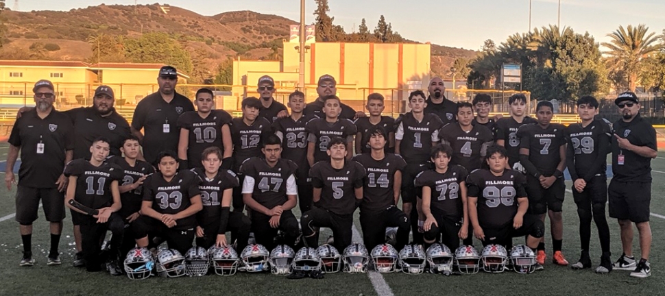The Fillmore Raiders Juniors Black team which will be heading to the GCYFL National Conference Superbowl at SoFi Stadium on Friday, November 11th, at 5:00pm. Juniors Black went undefeated during the regular season with a record of 7-0 to claim the number one seed in the National Conference (Division 1). They currently stand with a record of 9-0 after winning both rounds of play-off games. Your Fillmore Raiders Division 1 Juniors Black will face the Santa Barbara Saints in an unforgettable game. This will be Head Coach Chuy Jasso’s 3rd Super Bowl appearance for the Fillmore Raiders. Pictured above, top row: Coach Fred Perez, Coach Jose Rangel, Head Coach Chuy Jasso, Anthony Magaña, Caysen Michel, Coach Bobby Halcon, Abel Villela, Coach Beto Villela, JJ Jasso, Joshua Felix, Noah Halcon, Coach Michael Cardona, Efrain Arenas, Andrew Estrada, Saul Fraga, David Williams, Jerry Esquivel, and Coach Bubba Vaca. Bottom row: Phillip Alvarado, Elmer Santos, Isaac Gonzalez, Diego Ruiz, Jacob Aguilar, Rocky McDowell, Samuel Suarez, Angel Rangel, and Adam Cortez. 