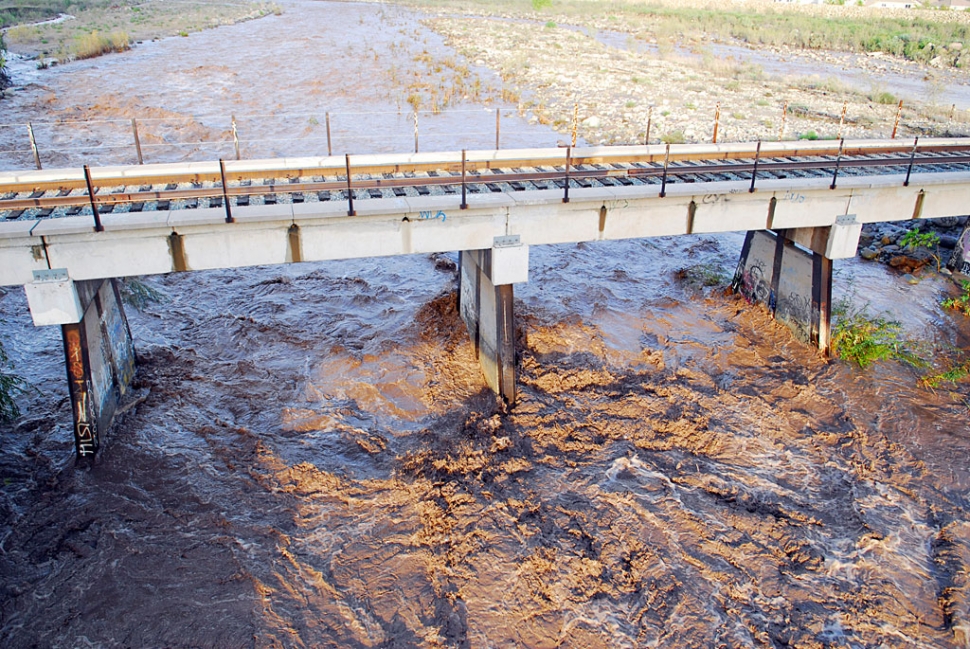 After little more than a day’s rainfall the Sespe Creek begins to roar. The day before only a trickle flowed through a parched, boulder creek bottom. By afternoon of the second day, a U.S. Geological Services (USGS) team measured the flow under the Old Telegraph bridge traveling past a 12-foot deep area, at 10-feet per second. The next storm will greatly increase the flow.