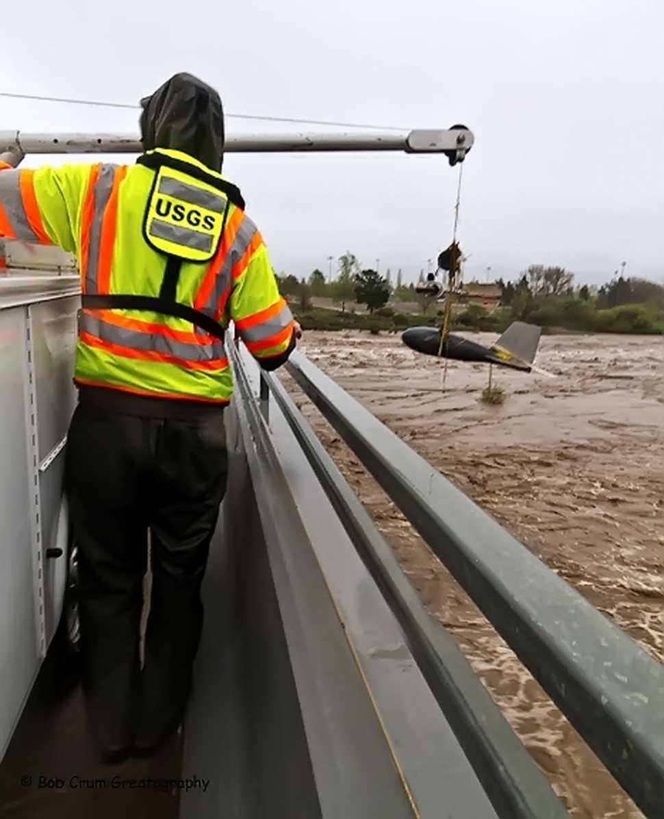 Preparing to lower the measuring device of Old Telegraph Road bridge into Sespe Creek.