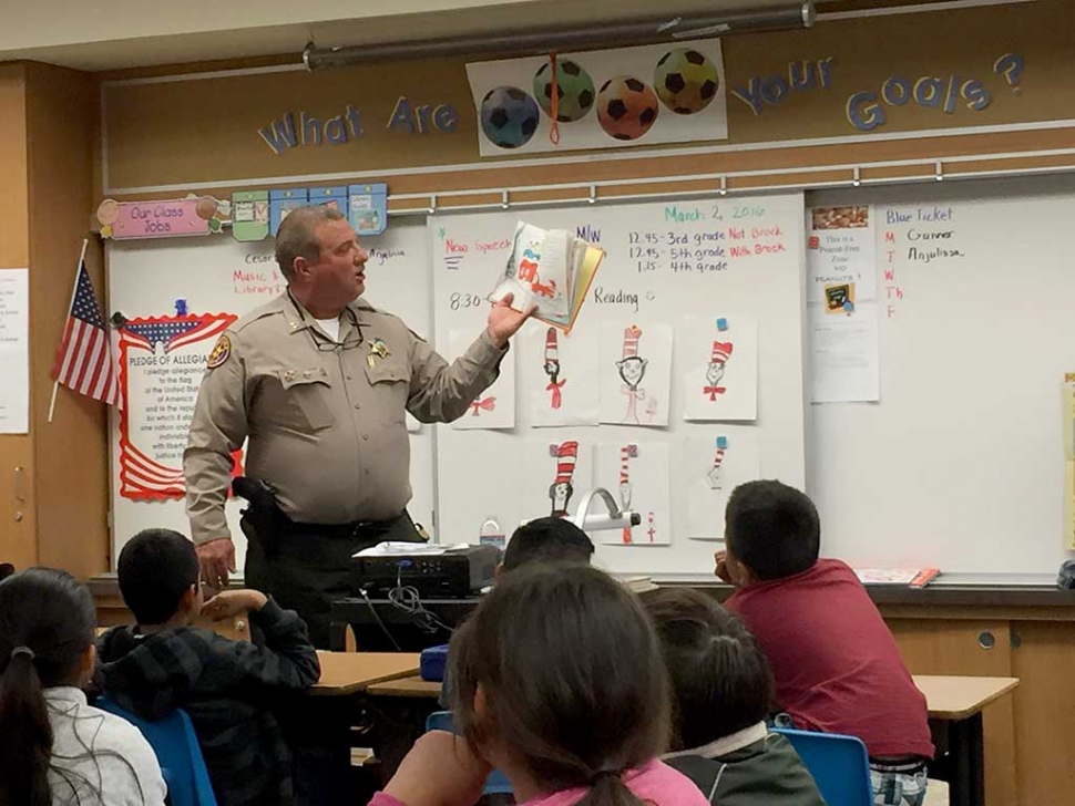 Captain Wareham reading to Mrs. Carmona's class. 