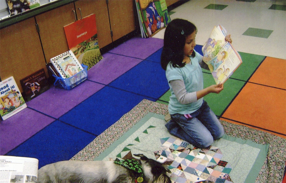 Anahi and Pepper the Reading Dog enjoy each other’s company.