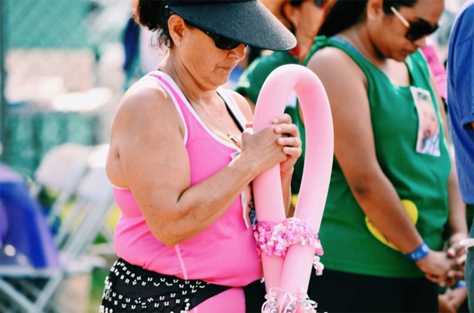 A Relay For Life participant holds a pink balloon while bowing in prayer, remembering loved ones who have lost
their lives to cancer, and those who have survived. The Relay 4 Life event took place Saturday and Sunday, September 12 & 13, at Shiells Park. Photos courtesy Adrian Rangel.