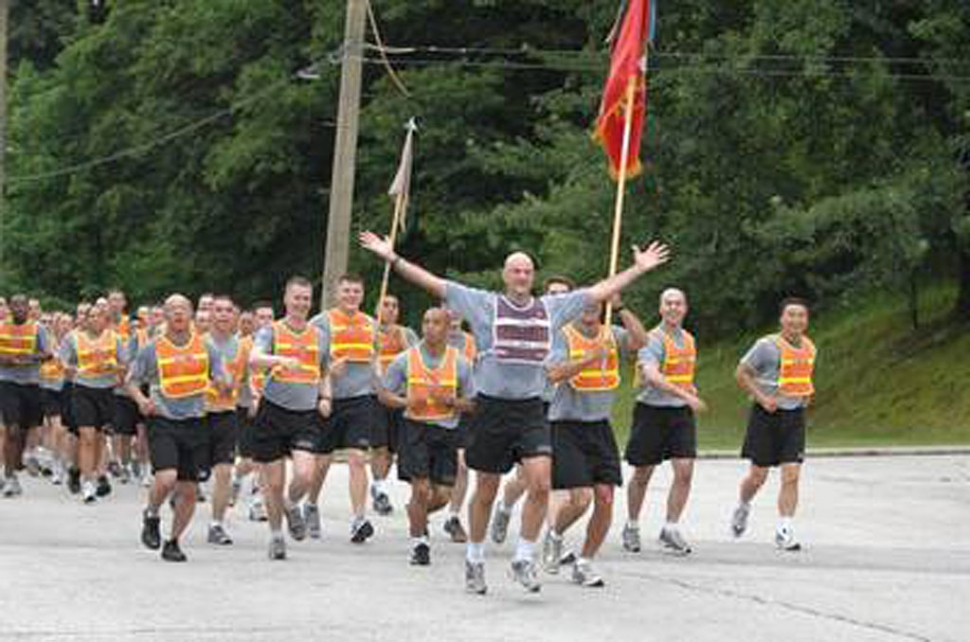 Then Lt. Col. Gordon Richardson, commander of 1st Battalion, 15th Field Artillery, takes his Soldiers across the finish line of a brigade run across Camp’s Casey and Hovey, South Korea. Photo courtesy U.S. Army; Photo Credit: Sgt Brad Cooper (About.com US Military).